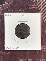 Reverse side of 1903 Great Britain Farthing coin depicting Britannia seated with trident and shield.