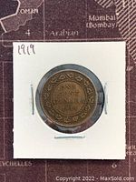 Reverse side of the 1919 Canadian large one cent coin showing denomination and year 1919 with decorative border.