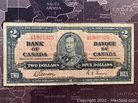 Front side of 1937 Canadian two dollar banknote showing King George VI portrait with serial number 1907325.