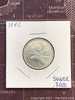 Obverse side of Canadian 1942 silver 25 cents coin showing caribou
