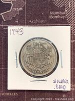 Front side of the 1943 Canadian 50 cent coin showing the coat of arms with crown and '50 cents' denomination.