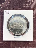 Obverse side showing the engravings of a lion lying on a crown, with the year 1968 and the text CANADA DOLLAR.