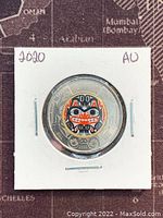 Obverse side of 2020 Canadian Bill Reid Twoonie, showing the colorized indigenous face design.