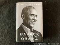 Front cover of the book showing Barack Obama smiling in black and white portrait.