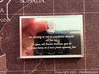 Silver bar with inscription side showing text about the opening of the St. Lawrence Seaway and a small portrait of Queen Elizabeth.