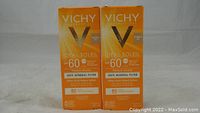 Two boxes of VICHY Ideal Soleil SPF 60 Ultra-Fluid Tinted Mineral Sunscreen Lotions shown side by side, front view.