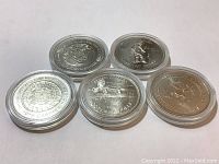 Five silver-colored 1978 British Columbia Indian Heritage Series II coins in clear protective cases arranged on a flat surface.