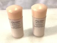 Front view of two small Shiseido Benefiance Wrinkle Resist 24 Night Emulsion bottles with peach-colored caps.