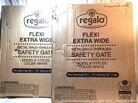 Two boxes of Regalo Flexi Extra Wide Metal Walk-Through Safety Gates in white, model 1175 DS, new in box, each box shows product details and dimensions.