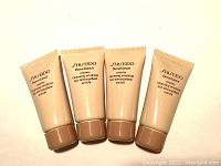 Four tubes of Shiseido Benefiance Creamy Cleansing Emulsion arranged side by side on a light background.
