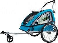 Commercial image of fully assembled Bell Sports Smooth Sailer bicycle child trailer stroller in blue with metal frame, large rear wheels, front caster wheel, and safety harnesses visible inside.