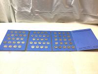 Full view of three open pages of blue Whitman Nickels collector book containing multiple Canadian 5 cent coins arranged neatly.