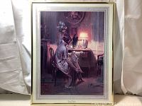 Full view of the framed art print showing the seated woman in a boudoir setting with warm lighting.