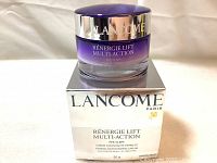 Photo of jar of Lancôme Rénergie Lift Multi-Action Firming Moisturizing Cream in purple gradient glass jar with silver lid on top of the original glossy silver box.