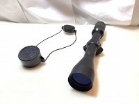 Matte black Simmons Truplex riflescope with lens covers attached, displayed on a white backdrop.