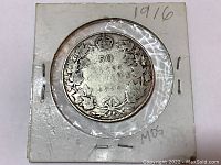 Reverse side of the 1916 Canadian 50 cent silver coin showing denomination '50 Cents' inside a maple leaf wreath and the year '1916', secured in a protective coin holder.