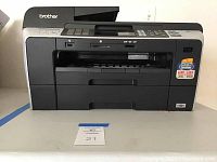 Front view of Brother multi-function center printer showing overall design and paper input area.