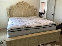 Full assembled king bedframe with mattress in bedroom