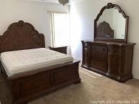 Overview of full queen bedroom set showing bed frame with mattress, headboard, dresser with mirror and nightstand