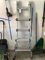 Full view of Vulcan 7-foot step ladder showing aluminum build and black plastic corner reinforcements.