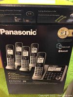 Box showing Panasonic cordless phone system with multiple handsets and model number
