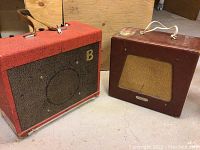 Both amplifiers side by side on concrete floor showing overall lot