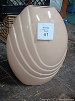 Front view of the beige glass decorative vase