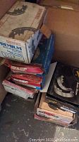 Photo of stacked original boxes containing the brake shoes showing various brands including Premium and ABP.