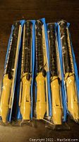 Five yellow and black soprano recorders in original sealed plastic packaging.