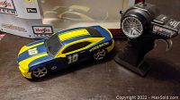 Maisto Tech 1:24 scale remote control car with racing design and controller next to box