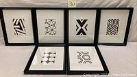 Set of six black and white abstract art prints in black frames arranged against white background, showing overall contents of the lot.