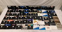 Row of approx. 66 black 5.25″ floppy disks laid out in rows