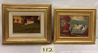 Two oil on board countryside paintings in gold-tone frames side by side on a wall, showing size and framing.