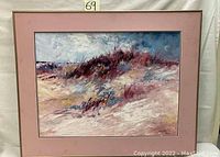 Framed and matted oil painting of a beach scene showing sand dunes and grasses with a cloudy sky