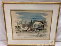 Full frontal view of framed watercolor painting depicting landscape with house and trees in a gold-tone frame.