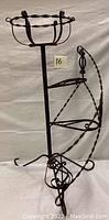 Full view of rustic iron spiral planter stand showing three spiral tiers and top circular pot holder.