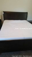 Front view of assembled sleigh bed with mattress