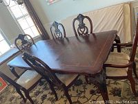 View of entire set showing table and six chairs from front