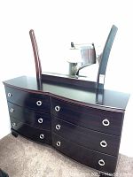 Front view of the merlot six drawer dresser with attached mirror, showing silver circular drawer pulls and wood finish.