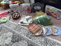 Wide view of all serving pieces and linens on carpet floor with various patterns and colors visible