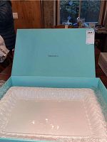 Porcelain platter displayed in original Tiffany & Co. blue box, placed on table in indoor setting.
