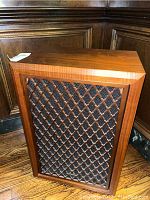 Speaker cabinet showing top and carved wooden grille overlay.