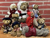Group photo of all 10 Boyd's Bears in various costumes and sizes on a brick background