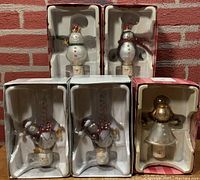 Six boxed Department 56 holiday night lights displayed in packaging includes penguin, snowman and angel figures.