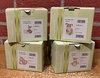 Four original boxes containing Hummel bunny figurines with product labels visible showing model names and numbers.