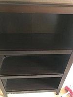 Photo showing the interior shelves and overall finish of the wooden bookcase, highlighting the adjustable shelves.