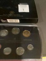 Photo of the 2006 Royal Canadian Mint Specimen Set showing several coins in the black display case with clear cover, along with the original box in the background.