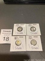 Four 1967 Canadian silver 10 cent coins in individual cardboard holders marked with year and 'silver'