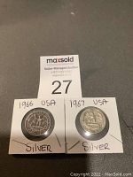 Two USA silver quarters from 1966 and 1967 in protective holders with handwritten labels.