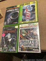 Photo of four Xbox game cases showing front cover art for Area 51, 007 Everything or Nothing, Blood Omen 2, and Brute Force